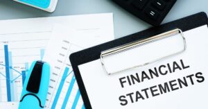 A blueprint-style infographic featuring a clipboard with the text "FINANCIAL STATEMENTS" prominently displayed.