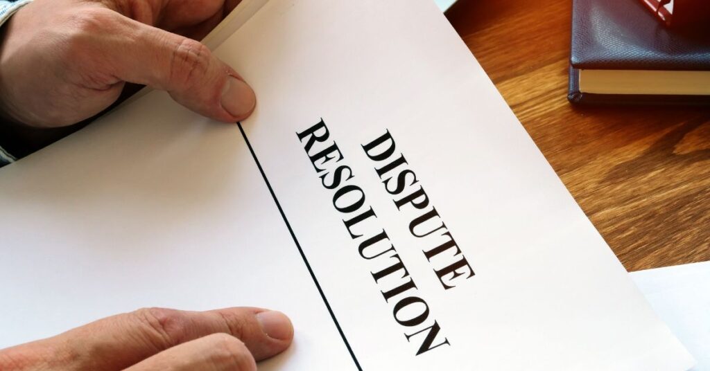 Image of hands holding a document with "DISPUTE".