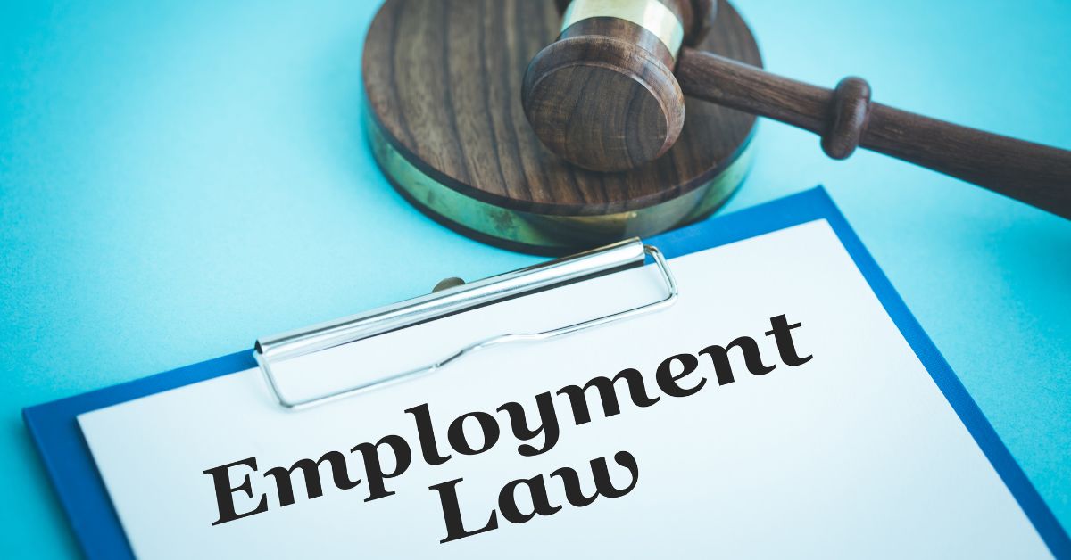 A gavel resting on a clipboard with the words "Employment Law" written on it, set against a blue background.