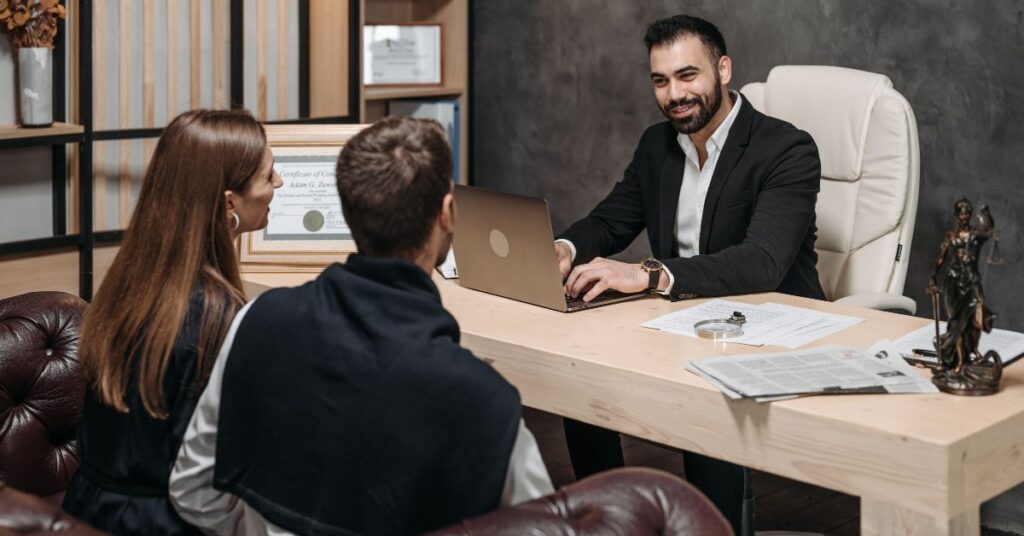 Clients are consulting with a lawyer about merger and acquisition details.