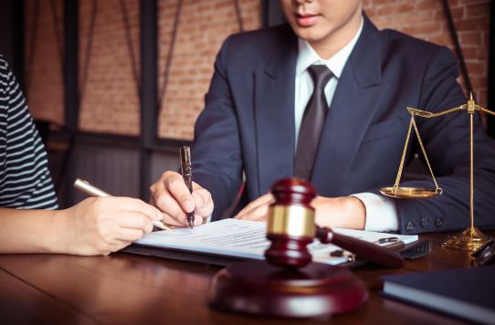Franchise lawyer in Toronto guiding a client through legal documents at the law office.