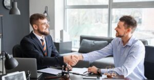 Franchise lawyer in Toronto finalizing a successful legal agreement with a client.