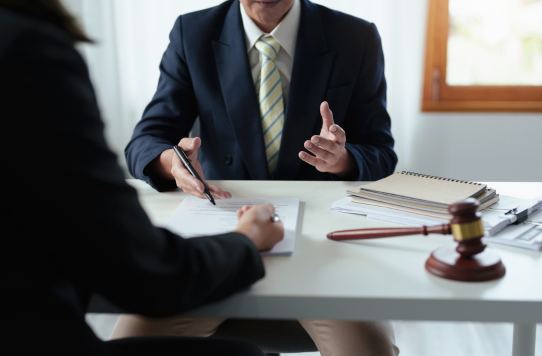 Franchise lawyer discussing legal documents with a client at a Toronto law office.