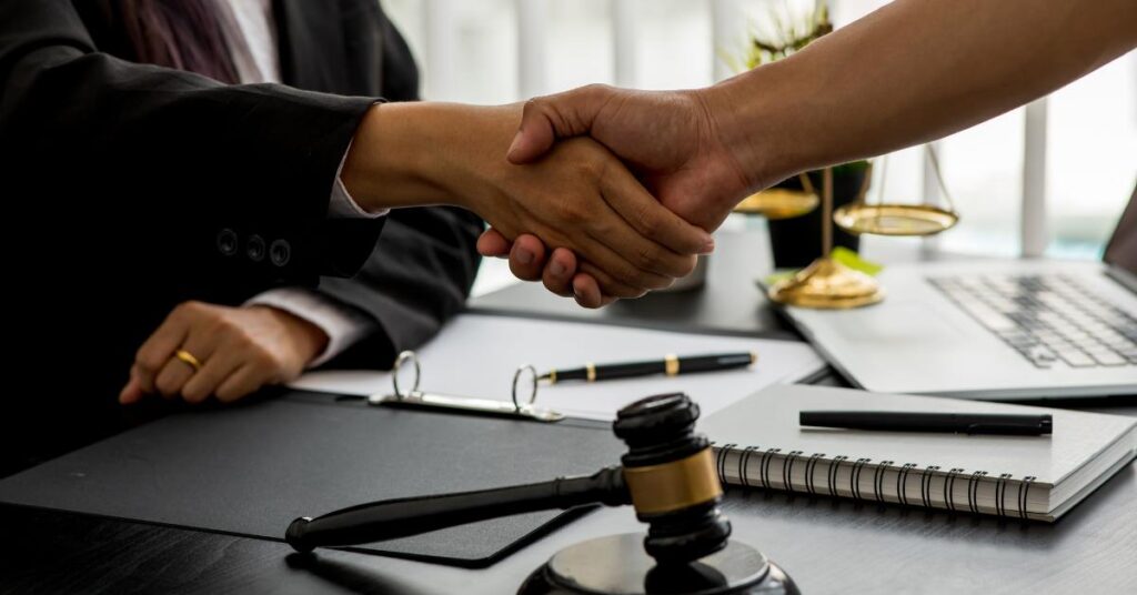 Client shaking hands with a lawyer in a legal office, representing trusted legal support – why hire an FDD preparation lawyer in Toronto.