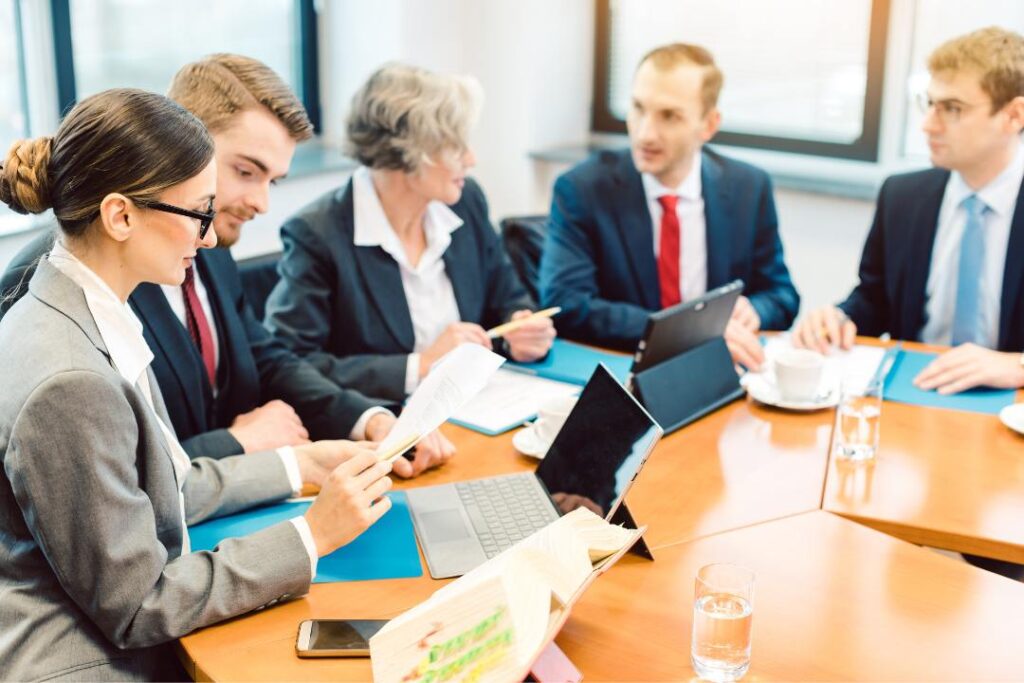 Business team in meeting discussing documents and strategies related to the different types of franchise agreements in Canada.