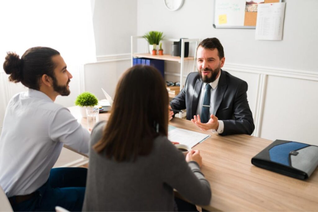 Senior man discussing documents with another person about the legal steps and requirements to break a franchise agreement in Canada legally.
