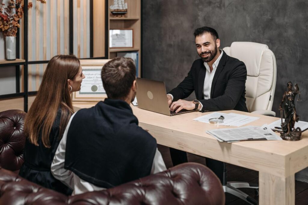 Lawyer meeting with clients to explain the key terms and protections of a franchise agreement in Canada under provincial franchise laws.