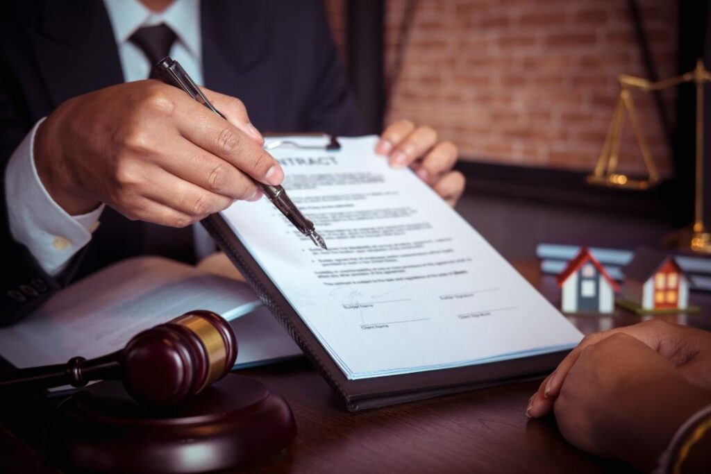 Lawyer explaining contract terms to client while reviewing legal documents related to choosing the best legal structure for a franchise.