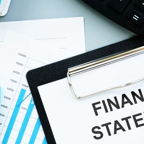 A blueprint-style infographic featuring a clipboard with the text "FINANCIAL STATEMENTS" prominently displayed.