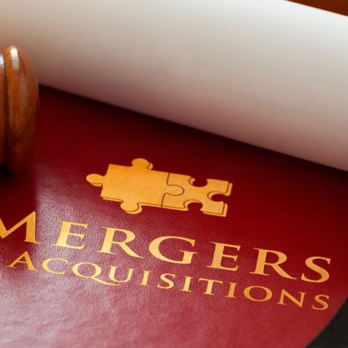 Gavel and legal documents with 'Mergers & Acquisitions' title, symbolizing the importance of legal expertise in business transactions.