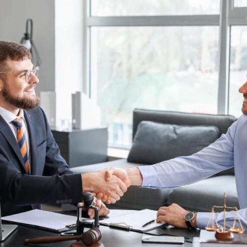Franchise lawyer finalizing a successful legal agreement with a client.